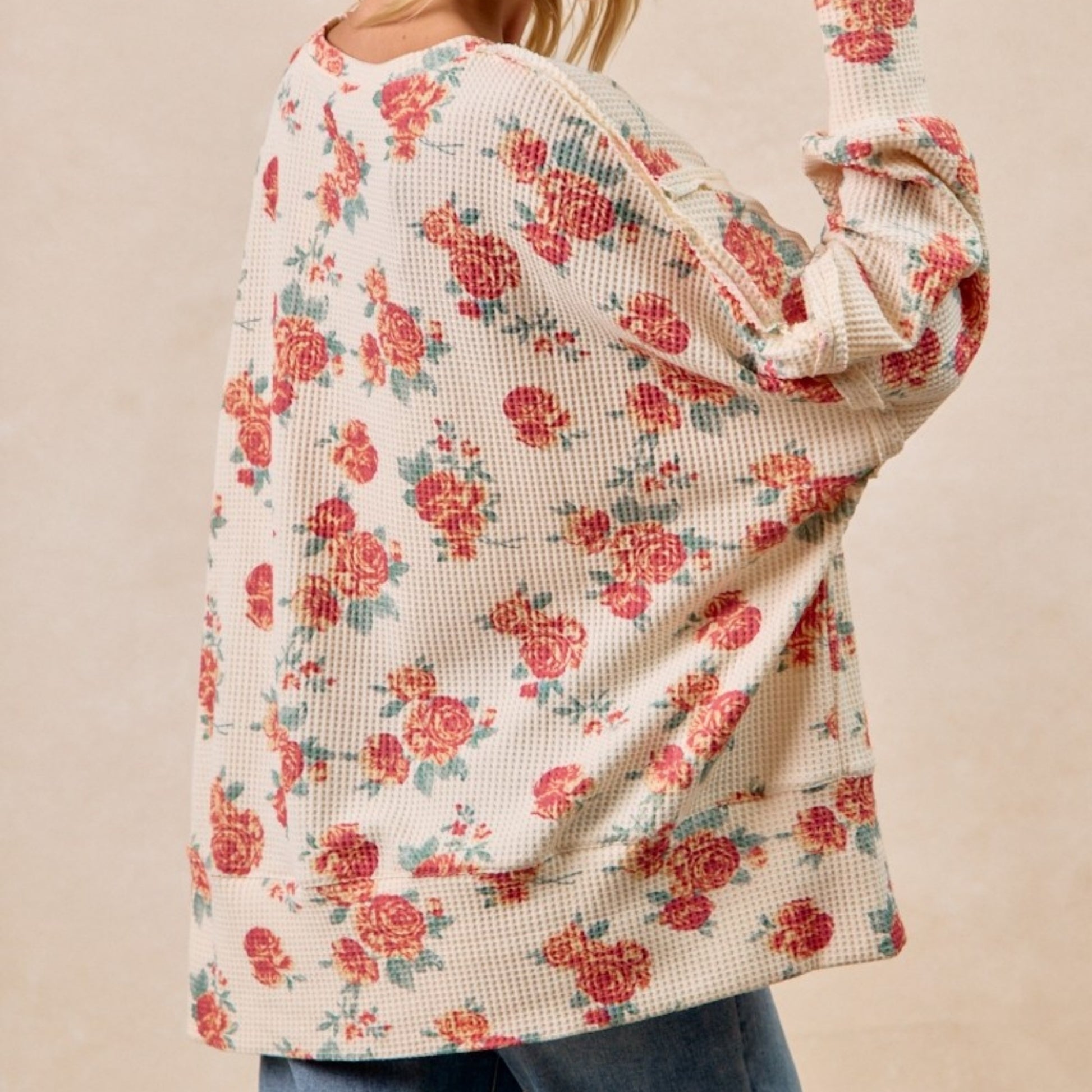 Floral patterned cardigan on a beige background