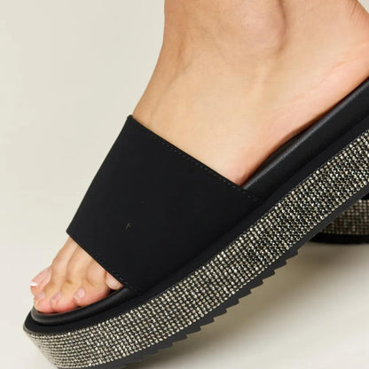 Close-up of the 2-inch platform sole and shimmering rhinestone details on Forever Link sandals.
