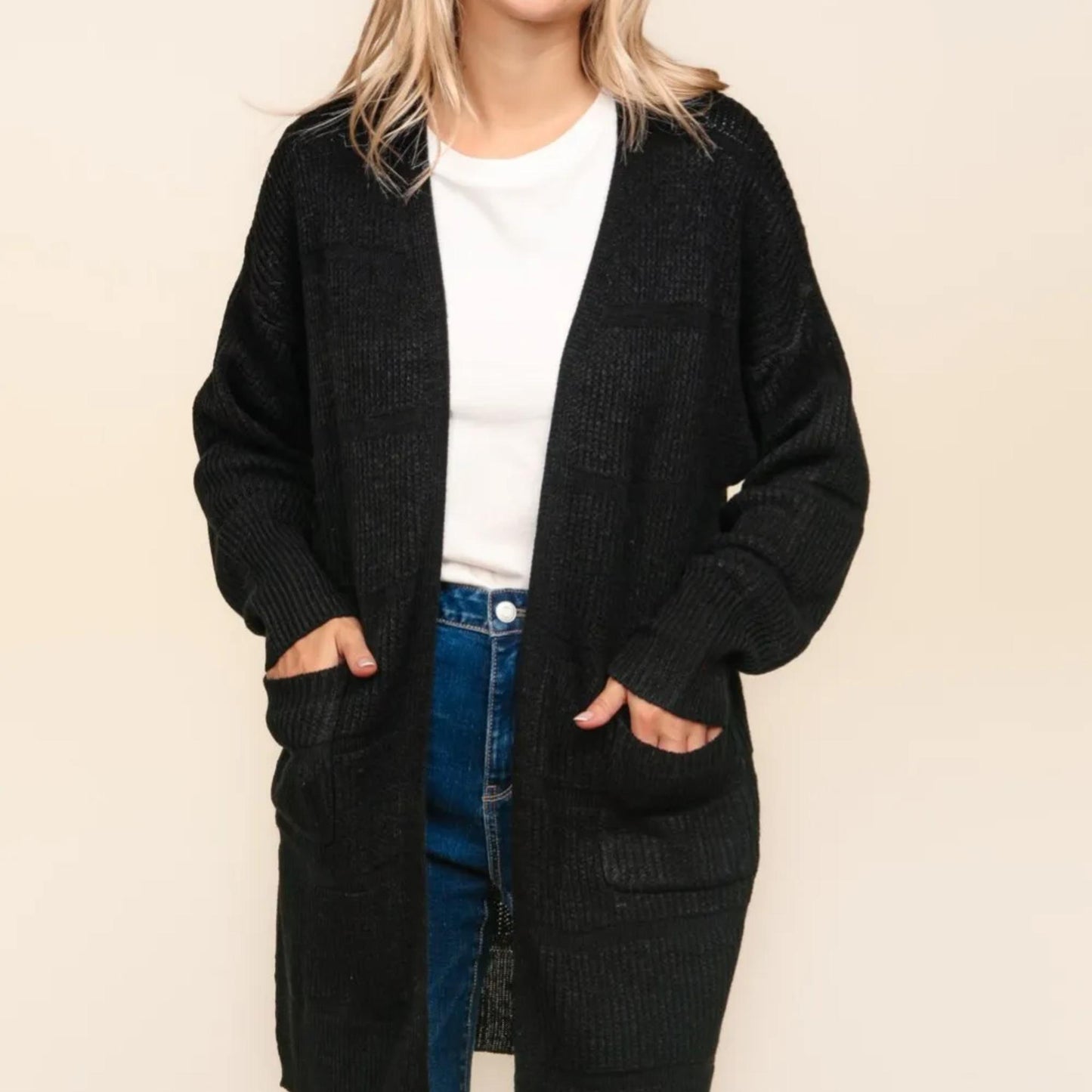 Close-up of the subtle tone-on-tone striped texture on the black Haptics cardigan.