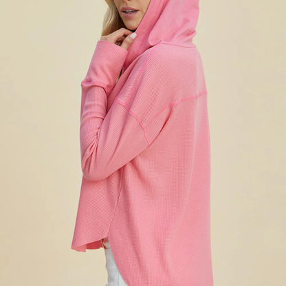 Back view of the pink long-sleeve hoodie highlighting the modern high-low hemline and cozy texture.