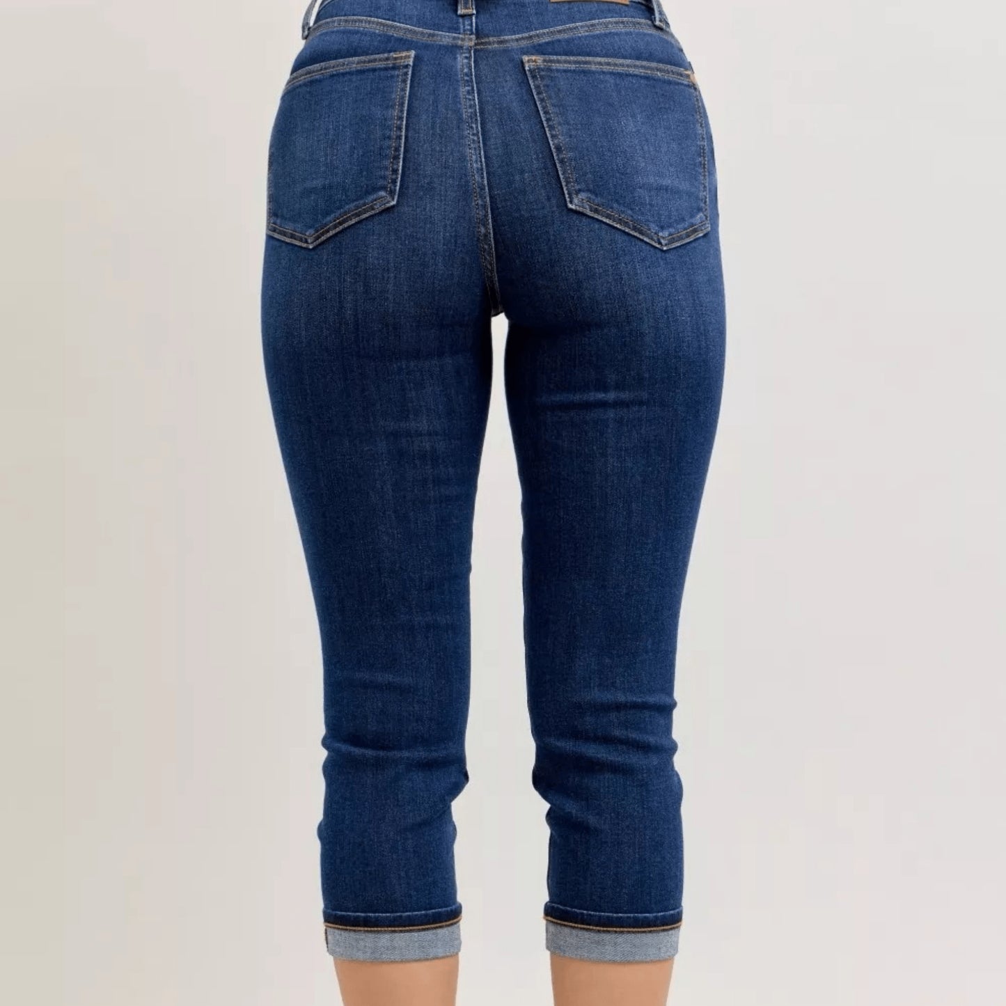Back view of high-waist summer capri jeans with classic pocket styling.