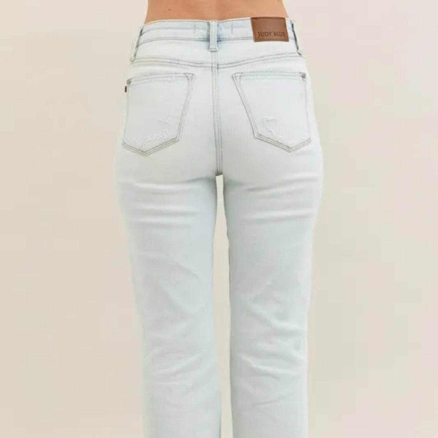 Model view of the high-waist destroyed bootcut denim.