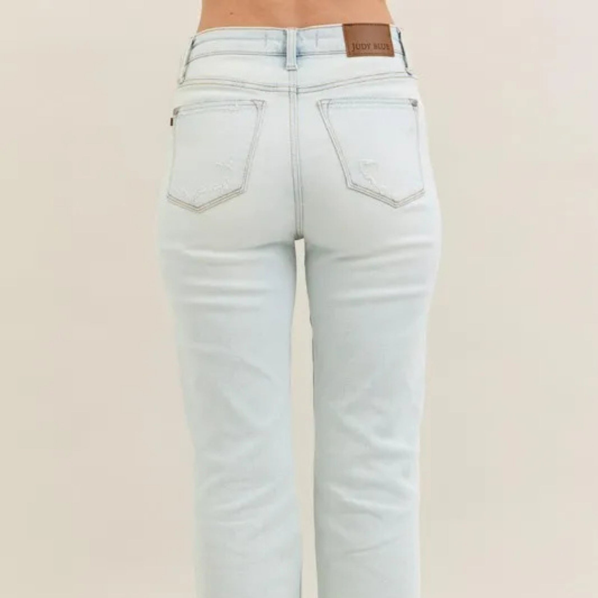 Model view of the high-waist destroyed bootcut denim.