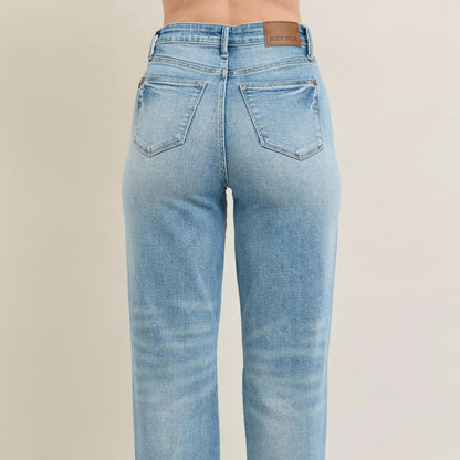 Back view of star-shaped destroy straight jeans showing high-waist fit.