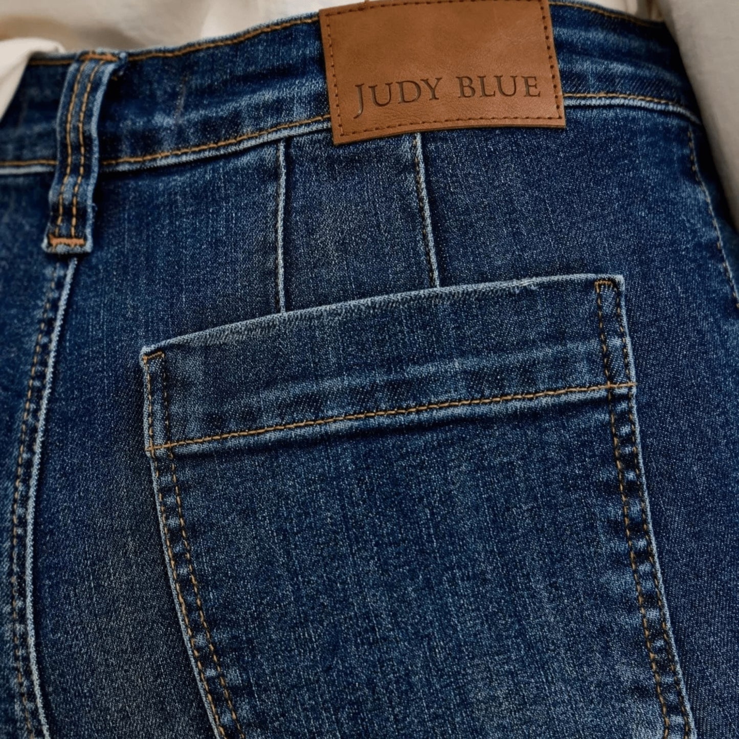 Detailed showcase of the Judy Blue label and patch pocket on wide-leg jeans.
