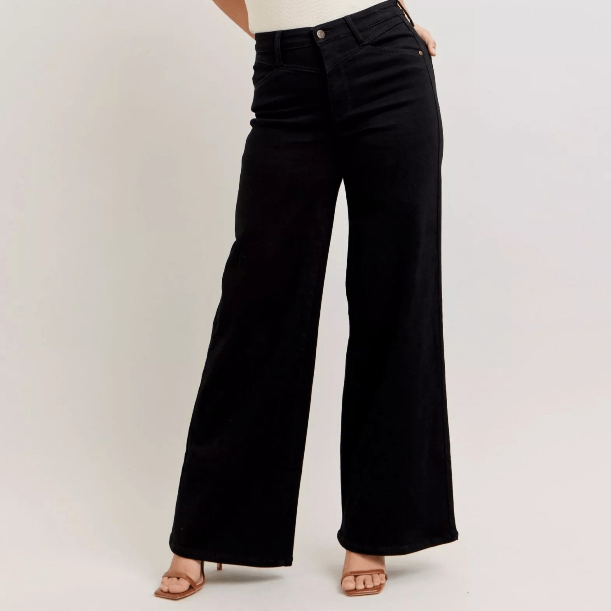 Frontal view of high-waisted black wide-leg jeans highlighting the cinched waist.