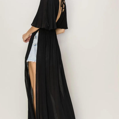 Showcasing the low side slits and flowy movement of the HYFVE Black cover up dress.