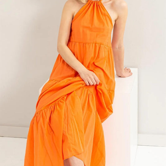 Lifestyle view of the HYFVE Orange maxi dress styled with a straw hat.