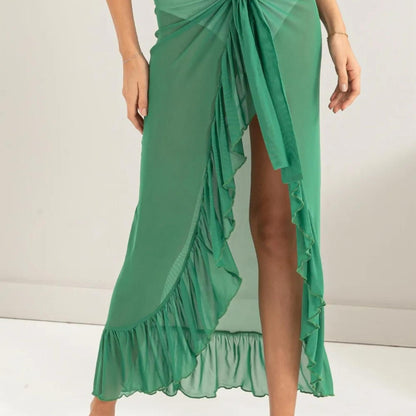 Lifestyle view of the HYFVE Green ruffled skirt styled for a beach outing.