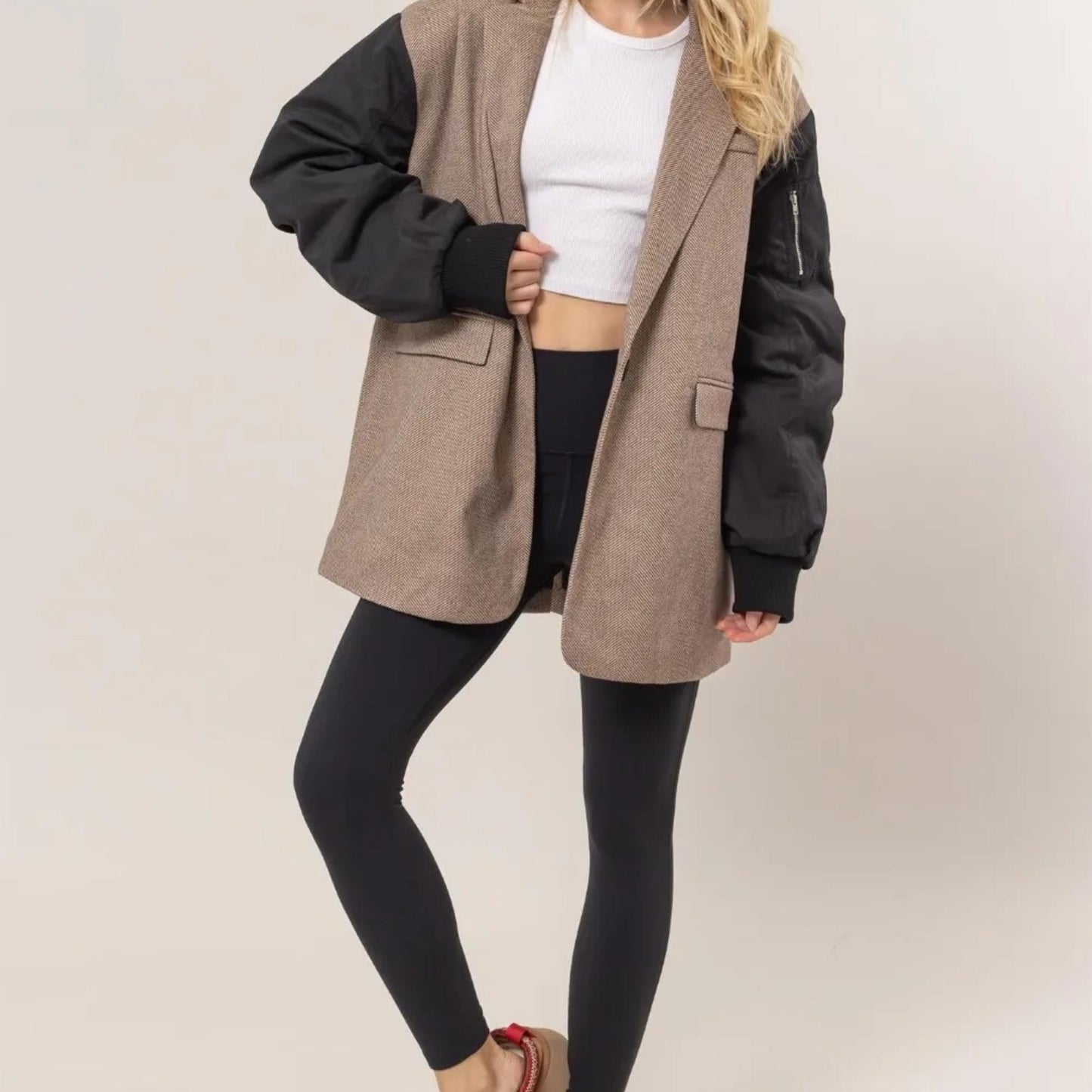 Lifestyle view of the HYFVE herringbone blazer styled for a professional, chic look.