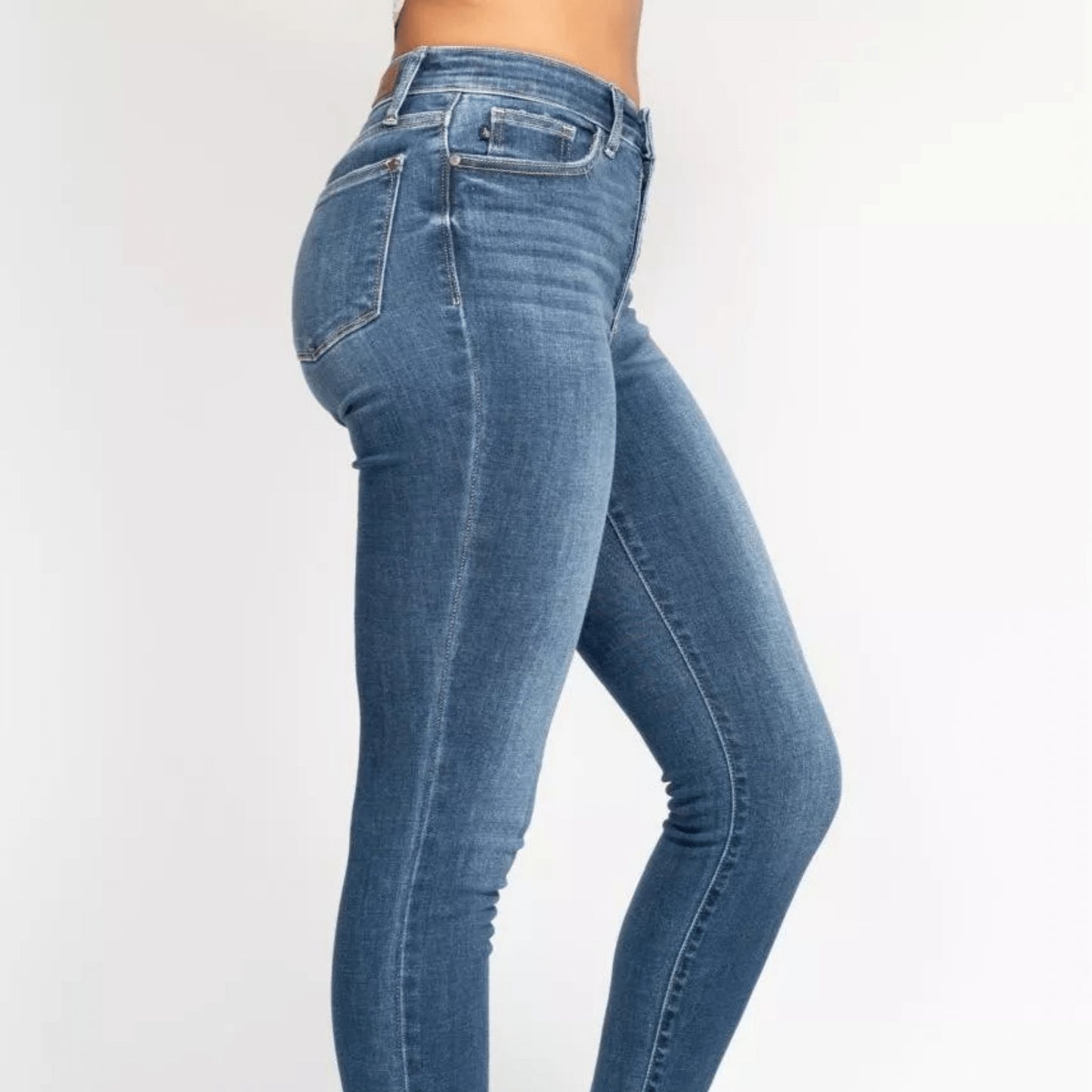 Frontal display showcasing the retro button fly on skinny jeans.