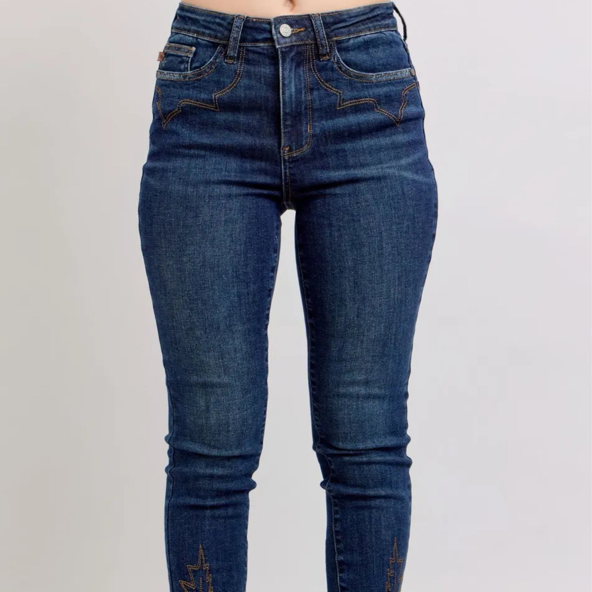 Full lifestyle view of the embroidered medium wash skinny jeans.