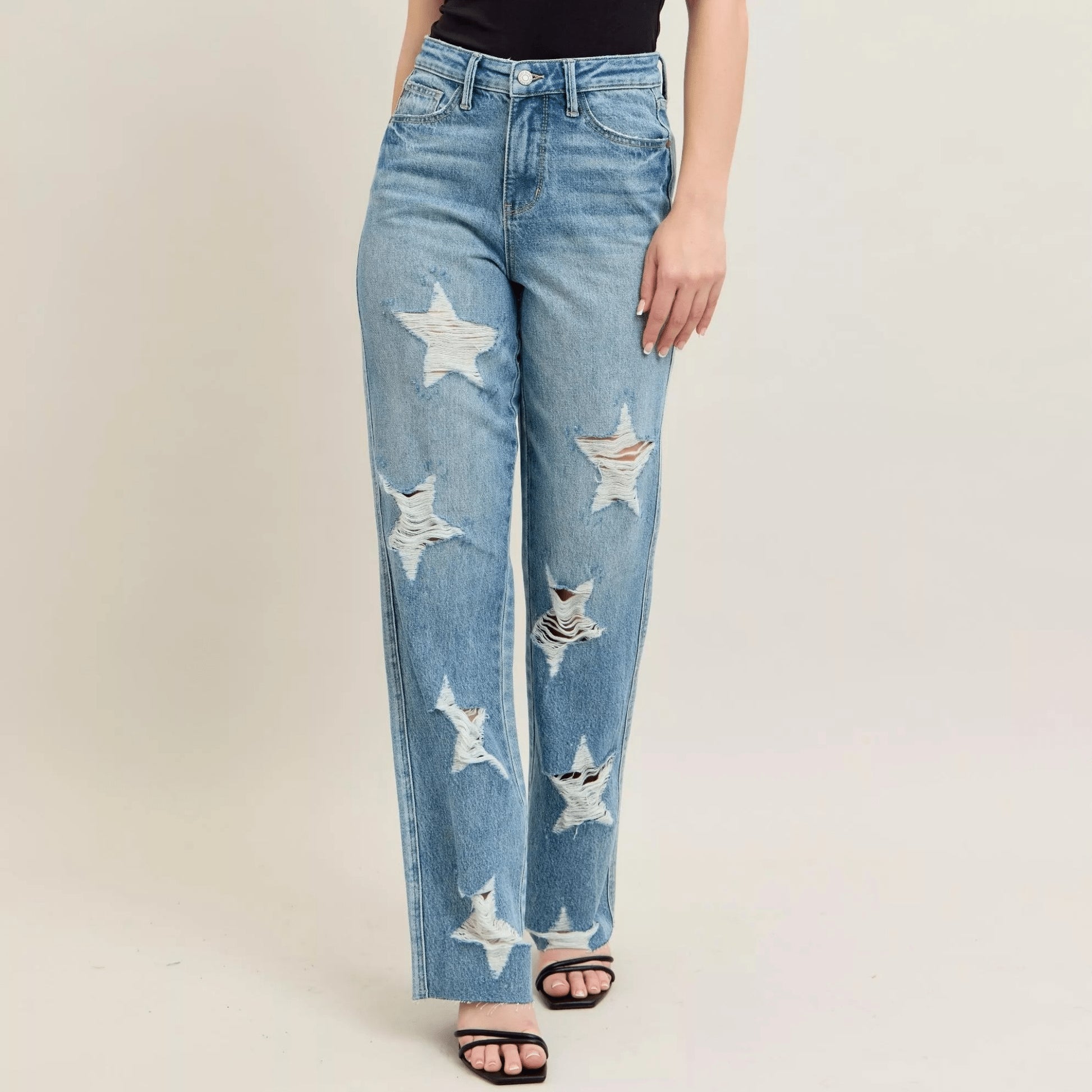 Frontal view of Judy Blue star-shaped destroy 90s straight jeans.