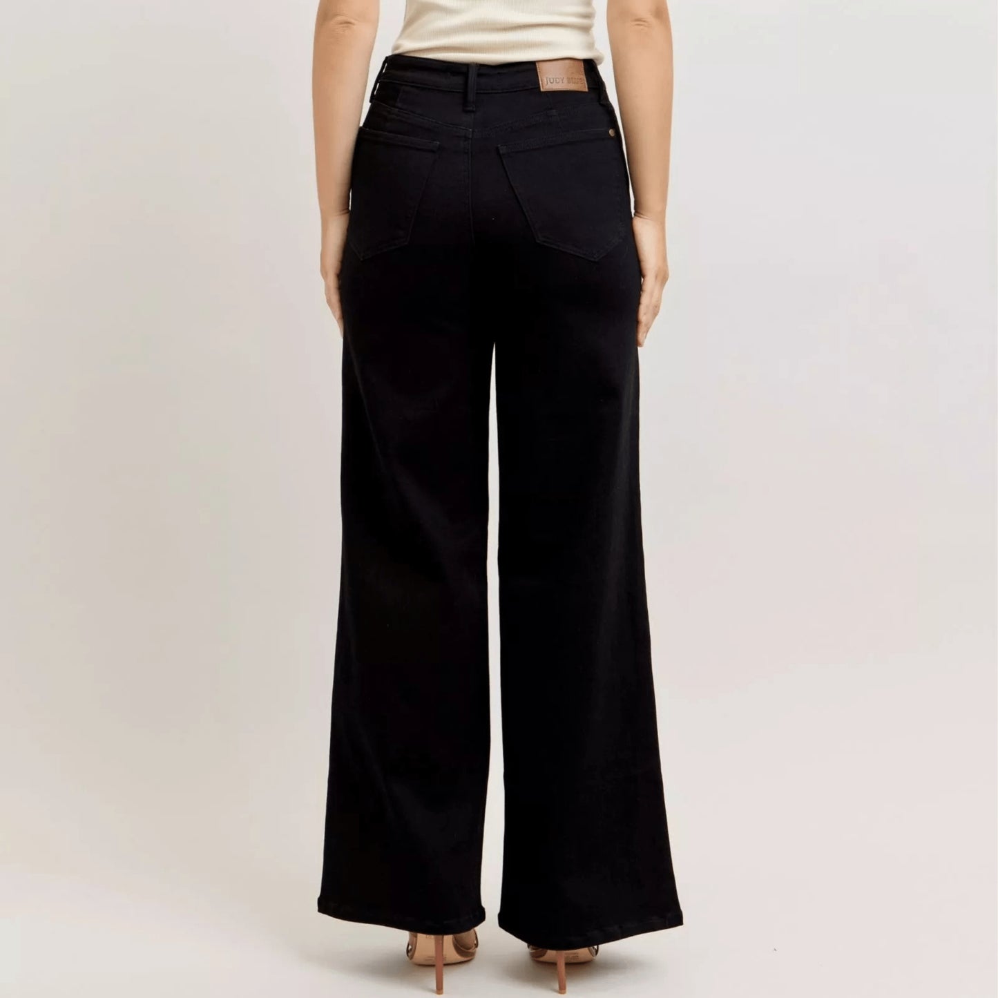 Close-up of the Judy Blue button and hardware on black wide-leg denim.