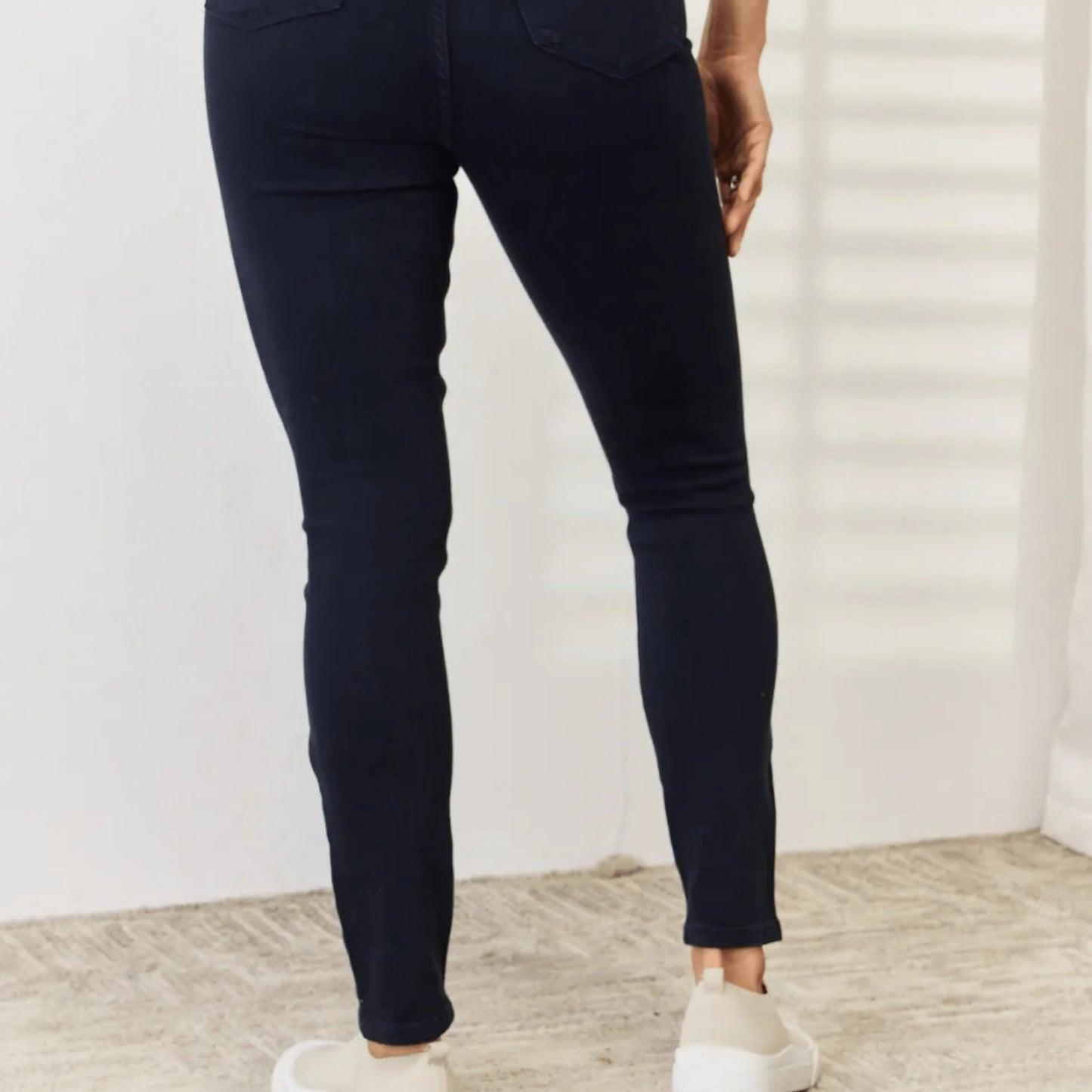 Final model presentation of the navy tummy control skinny jeans.