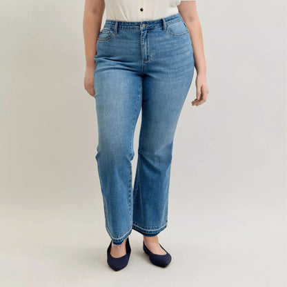 Full view of Judy Blue plus size bootcut jeans with a white blouse.