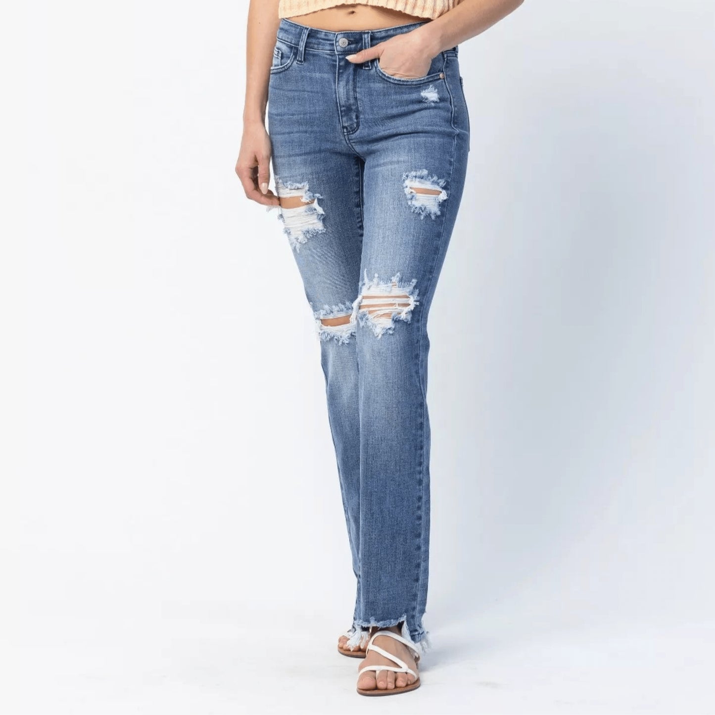 Full length view of Judy Blue plus size straight leg jeans with ripped accents.