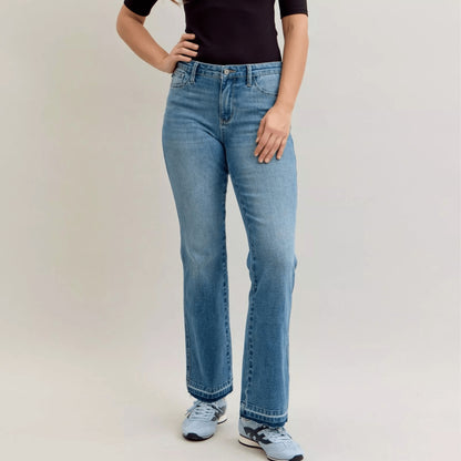 Woman wearing Judy Blue slim bootcut tummy control jeans in medium wash.