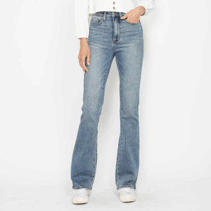 Person wearing light blue jeans on a white background