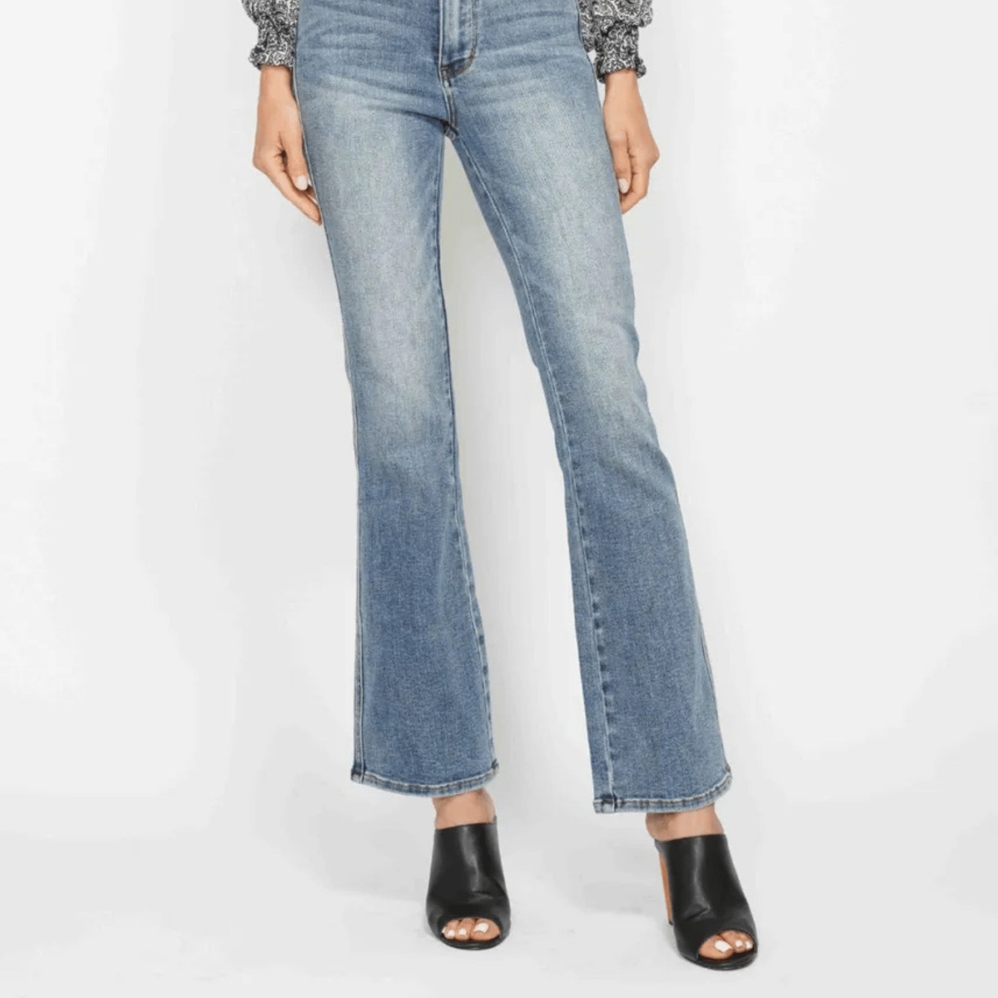 Person wearing light blue jeans on a white background