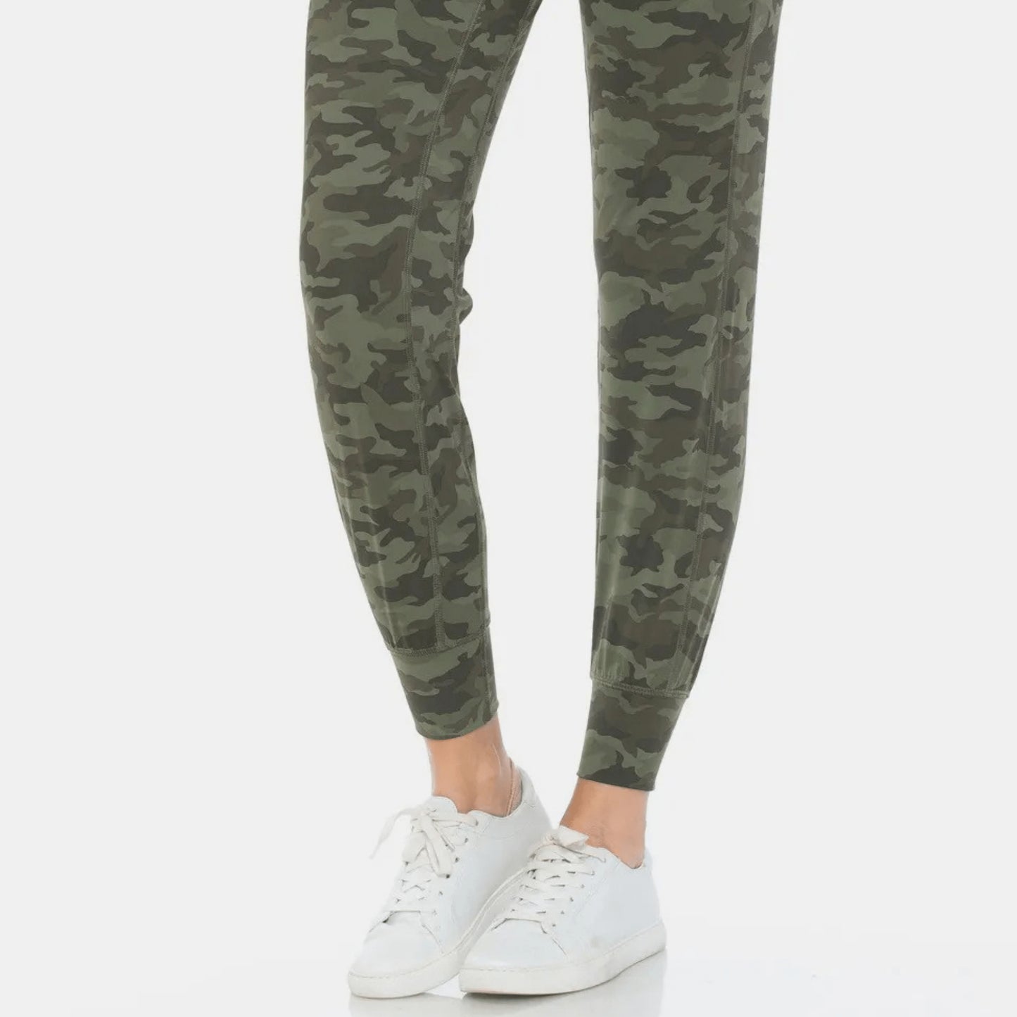Lifestyle shot of a woman wearing camo print leggings for a trendy athleisure boutique look.