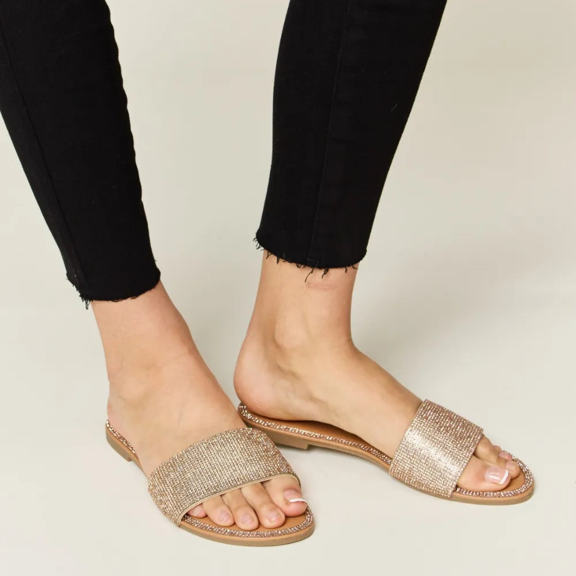 Lifestyle image of the rhinestone sandals styled for a sophisticated summer look.