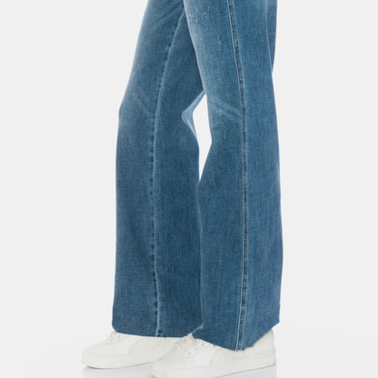 Lifestyle shot of a woman wearing raw hem straight jeans for a trendy boutique outfit.
