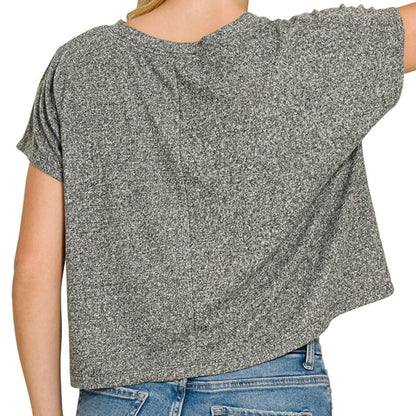 Lifestyle view of the Black drop shoulder cropped top styled for a modern coastal aesthetic.