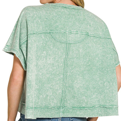 Lifestyle view of the dark green oversized top styled for a realistic boutique look.