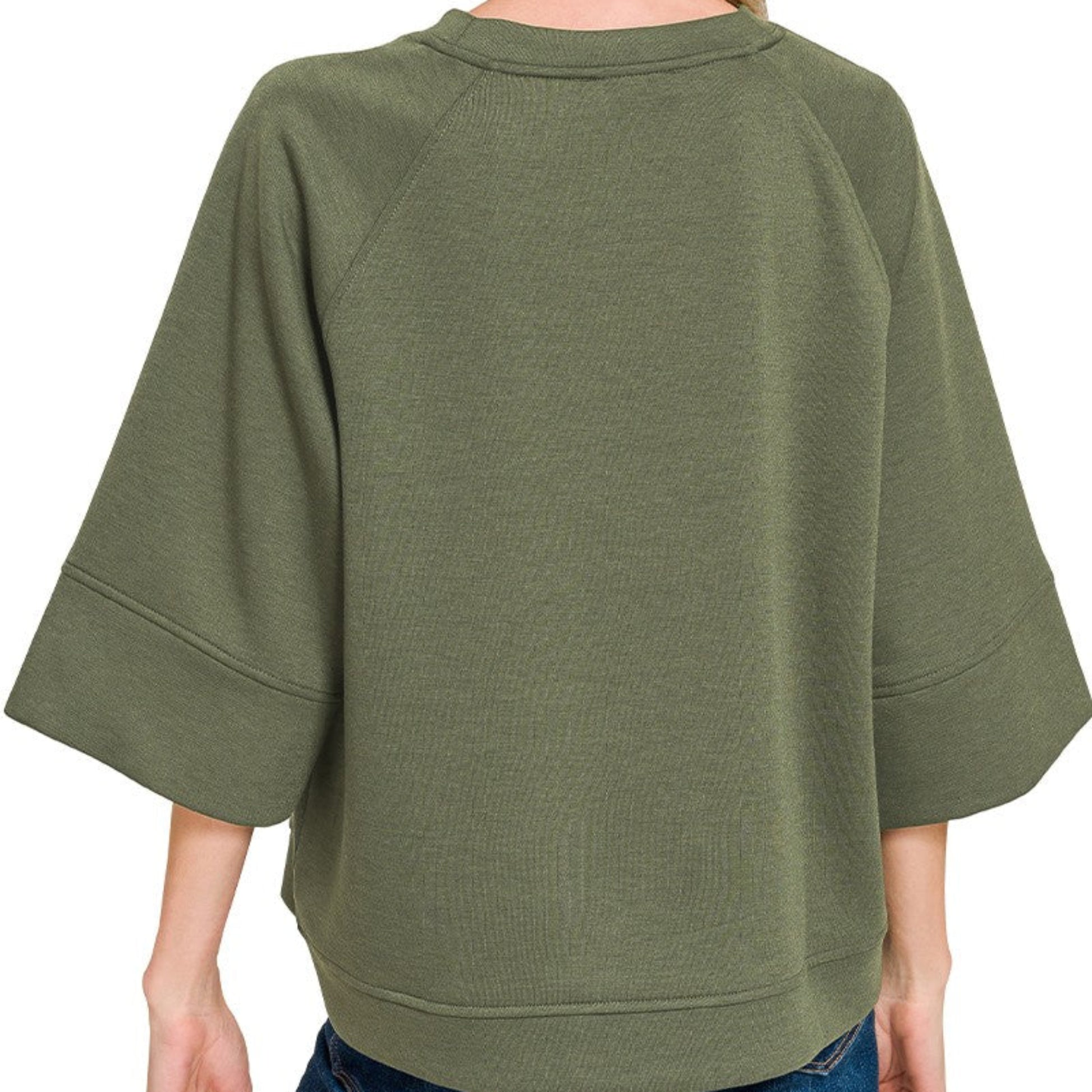 Lifestyle view of the Dark Olive 3/4 sleeve pullover styled for an effortless, modern look.