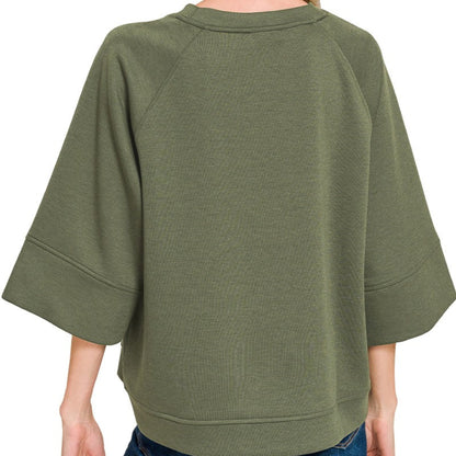 Lifestyle view of the Dark Olive 3/4 sleeve pullover styled for an effortless, modern look.