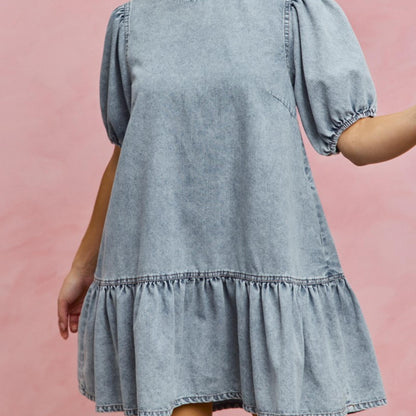 Full-length view of the SO ME light wash denim mini dress styled for summer.