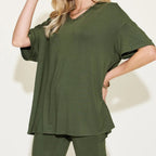 Person wearing a matcha green t-shirt and pants against a white background