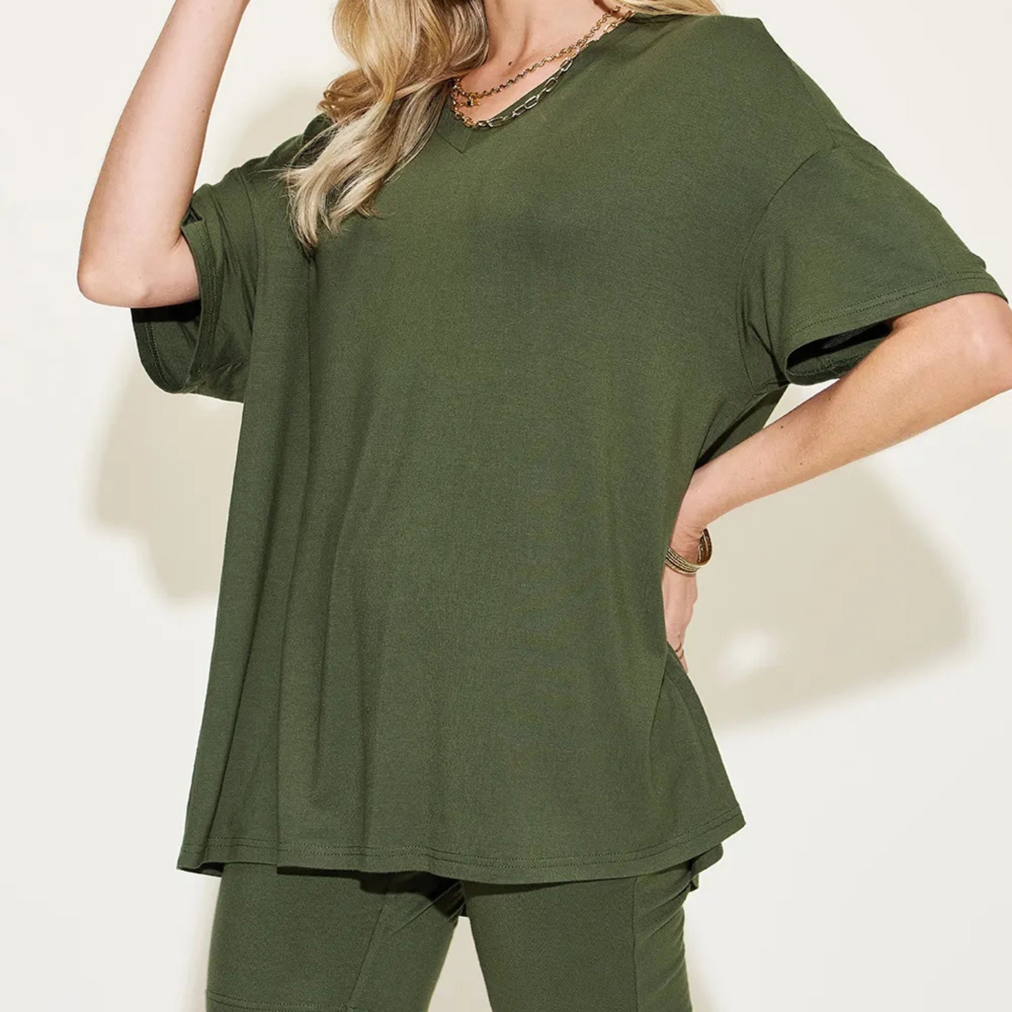 Person wearing a matcha green t-shirt and pants against a white background