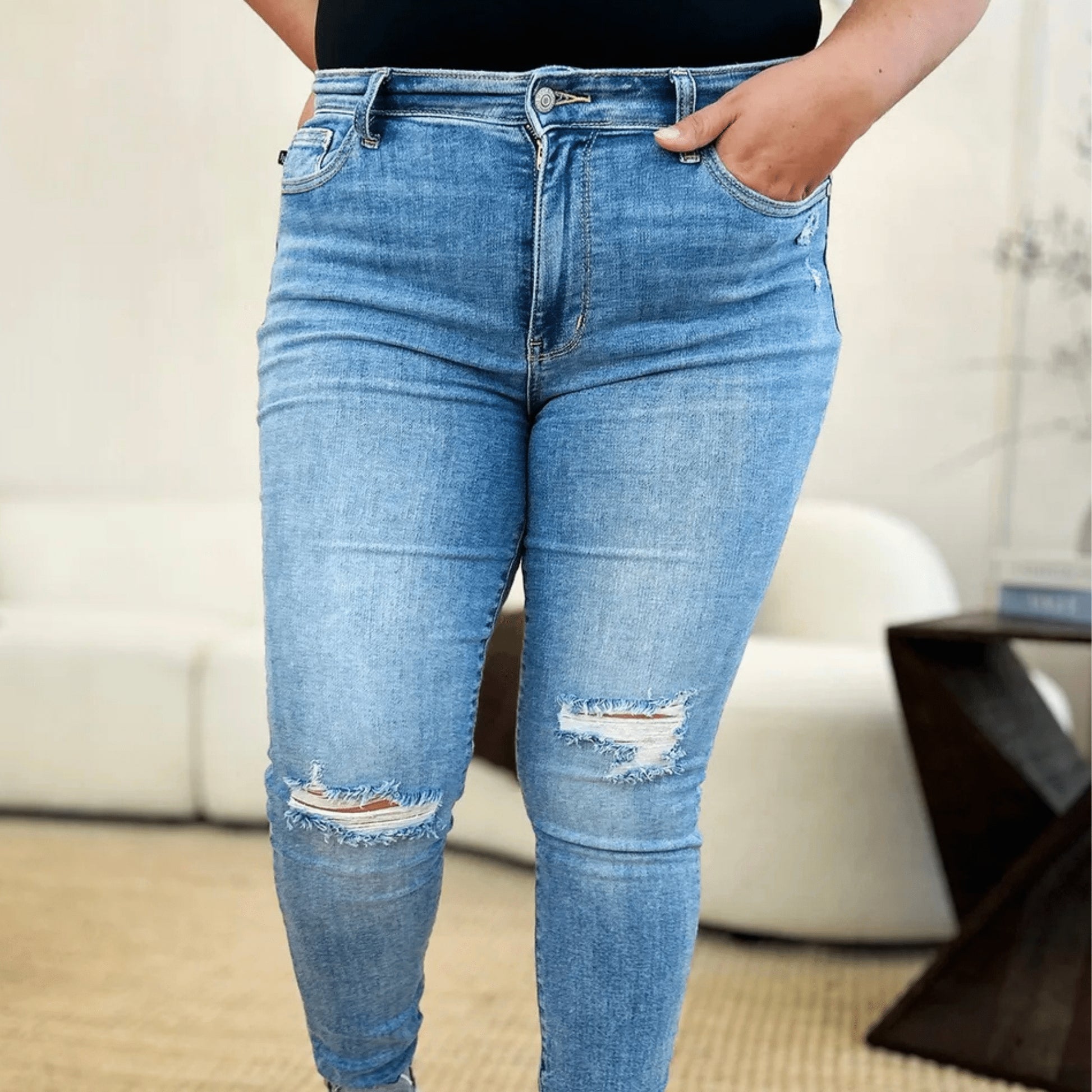 Lifestyle view of Judy Blue mid-rise skinny jeans styled casually.