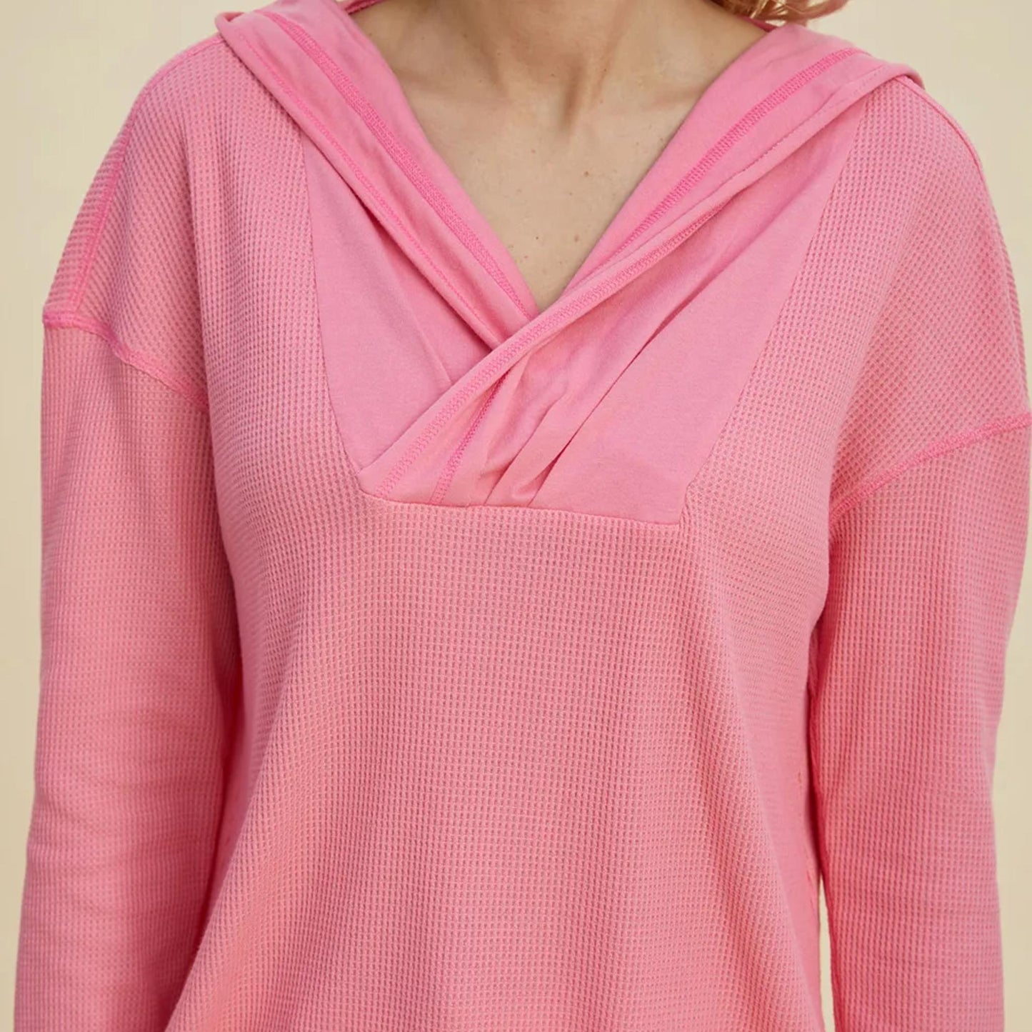 Full model shot of the pink dropped shoulder hoodie, showcasing its oversized fit and versatile style.