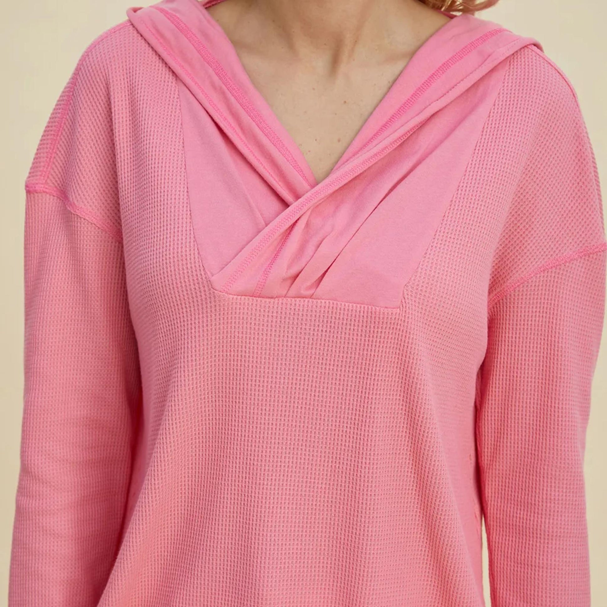 Full model shot of the pink dropped shoulder hoodie, showcasing its oversized fit and versatile style.