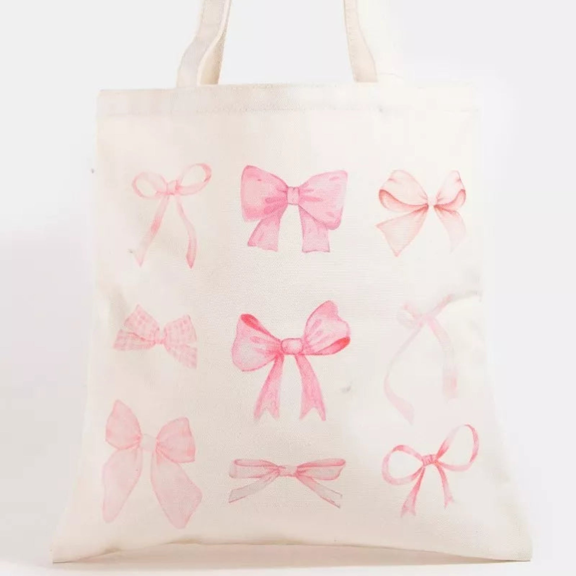 Pink ribbon bow tote bag with a sweet pink bow design and sturdy white shoulder straps