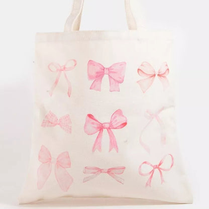 Pink ribbon bow tote bag with a sweet pink bow design and sturdy white shoulder straps
