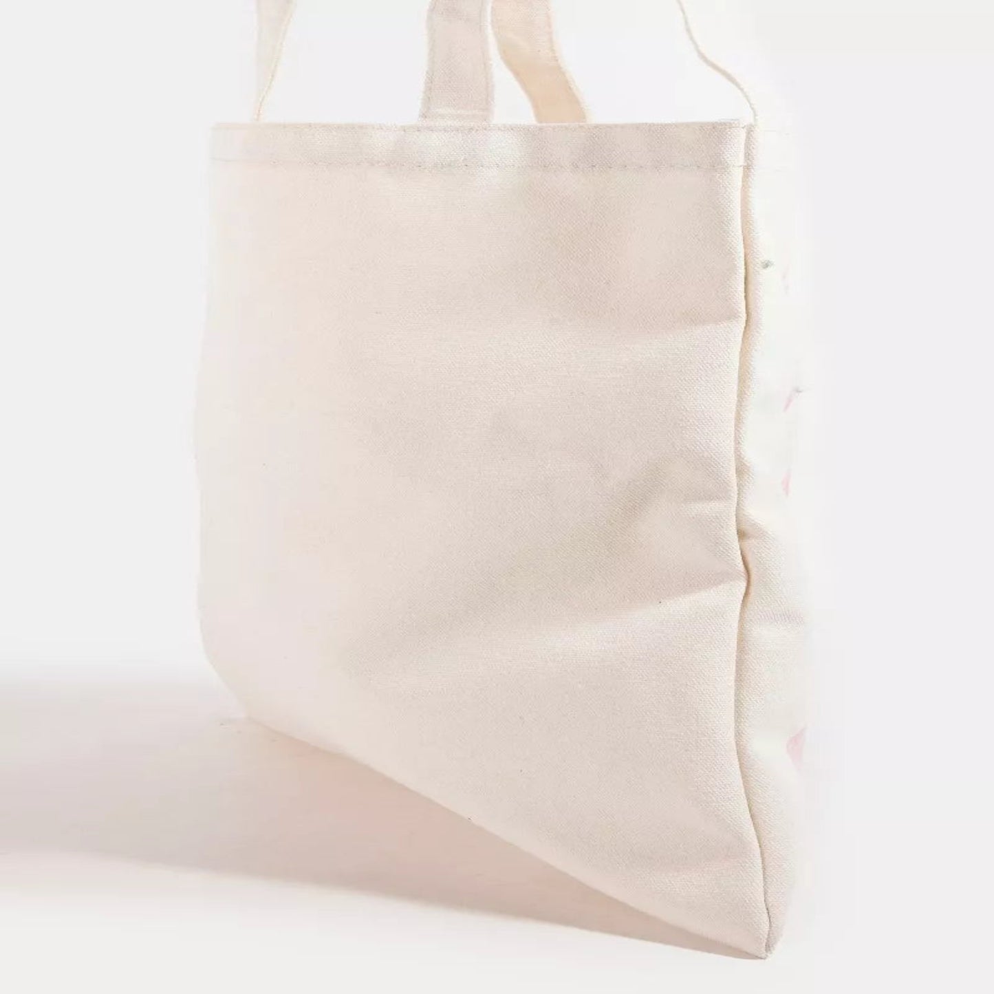 Close-up of the pink ribbon bow tote bag showing the soft material and delicate bow pattern