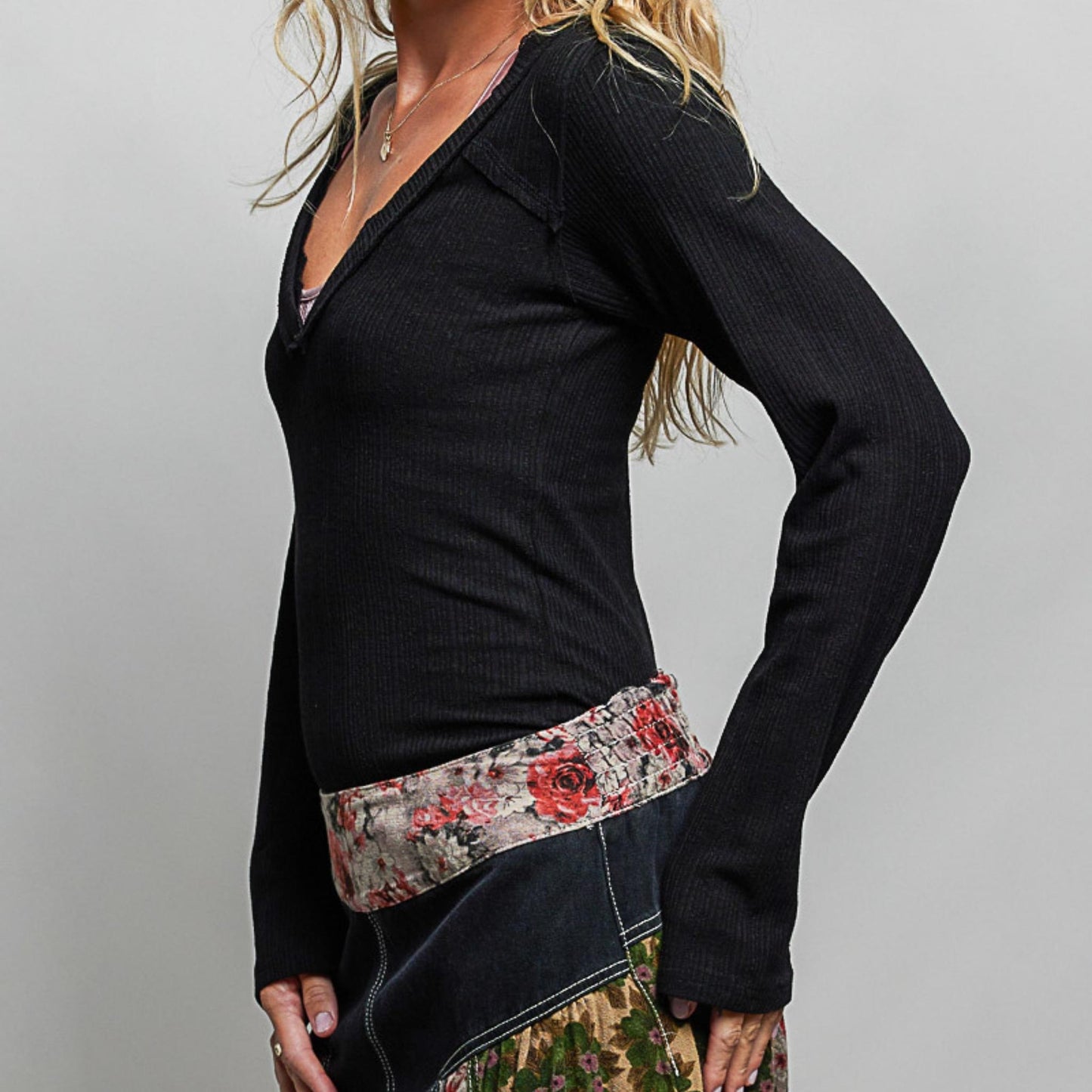 POL black v-neck long sleeve ribbed top showing slim fit — side perspective.
