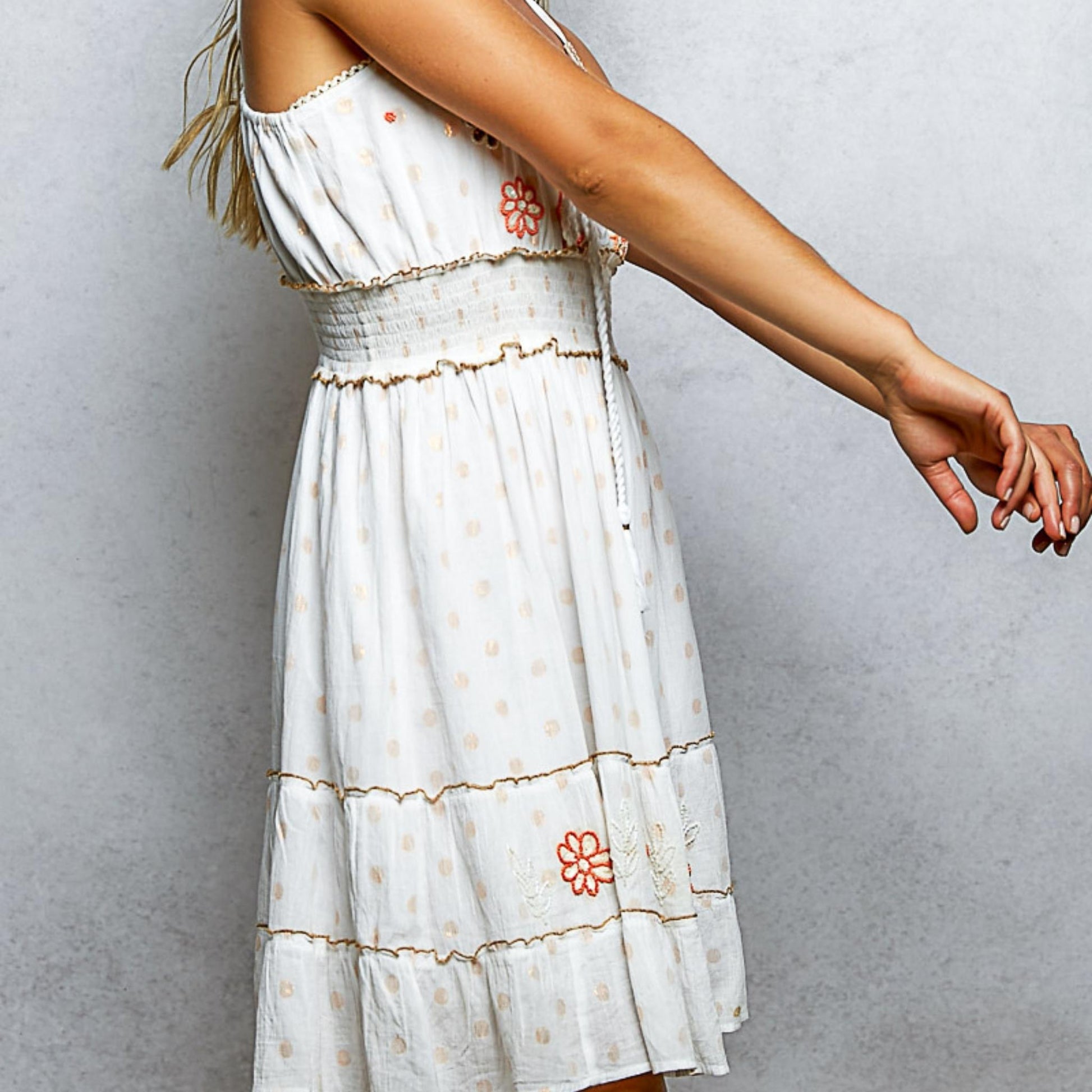 Side perspective of the ivory boho cotton sundress highlighting the embroidery.