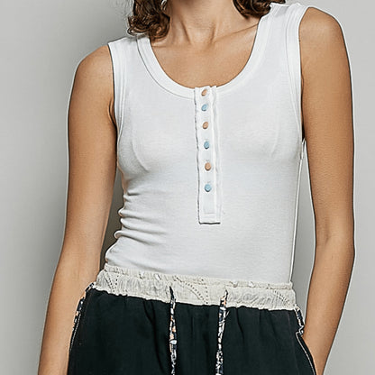 Frontal view of a woman wearing the POL fitted ribbed tank in off-white.
