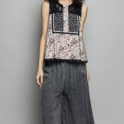Lifestyle styling of the POL lace back top with wide-leg summer trousers.