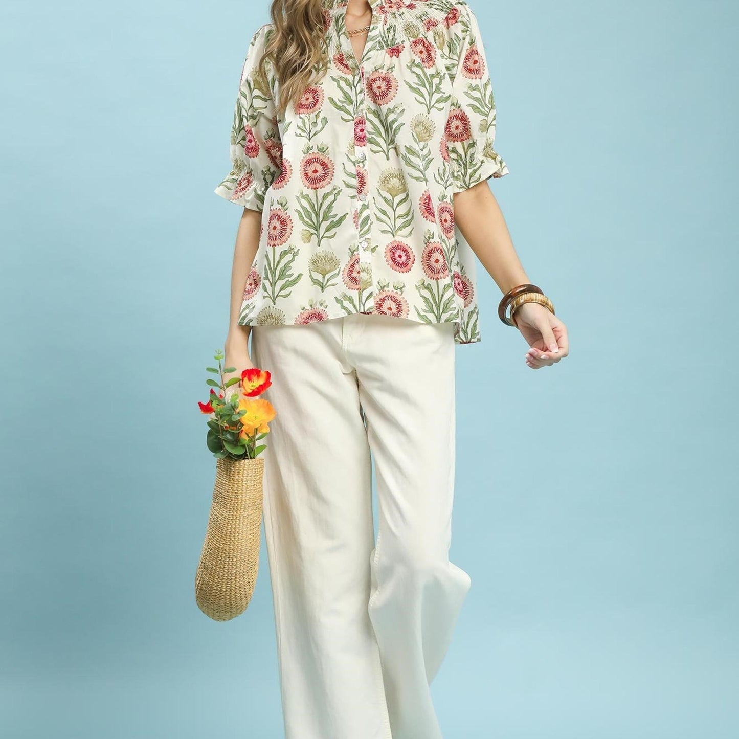 Lifestyle view of the Umgee floral top paired with denim for a casual, bohemian-inspired outfit.