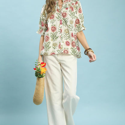 Lifestyle view of the Umgee floral top paired with denim for a casual, bohemian-inspired outfit.