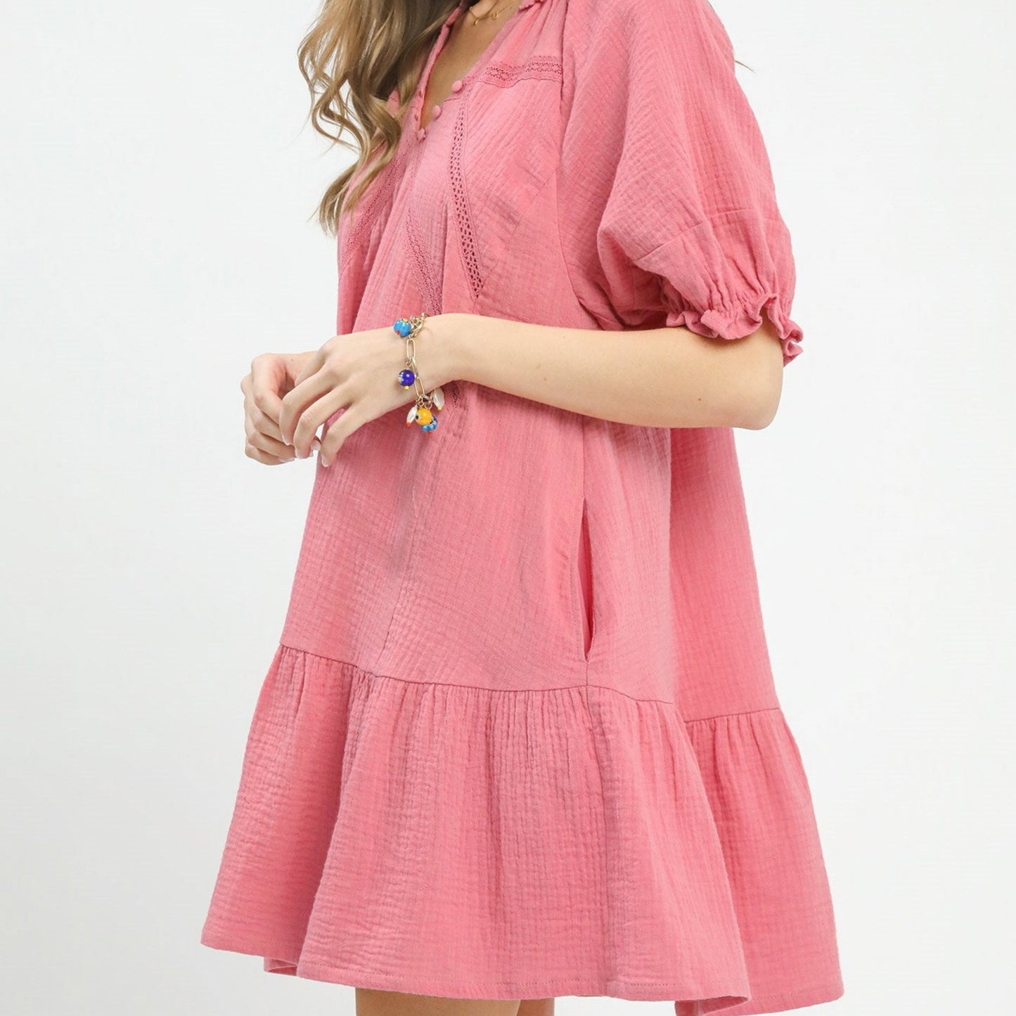 Pink dress worn by a person on a white background
