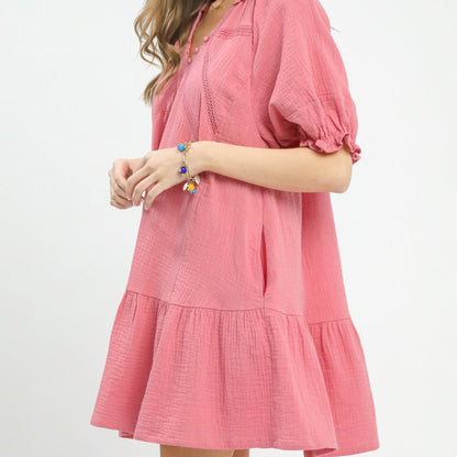 Pink dress worn by a person on a white background