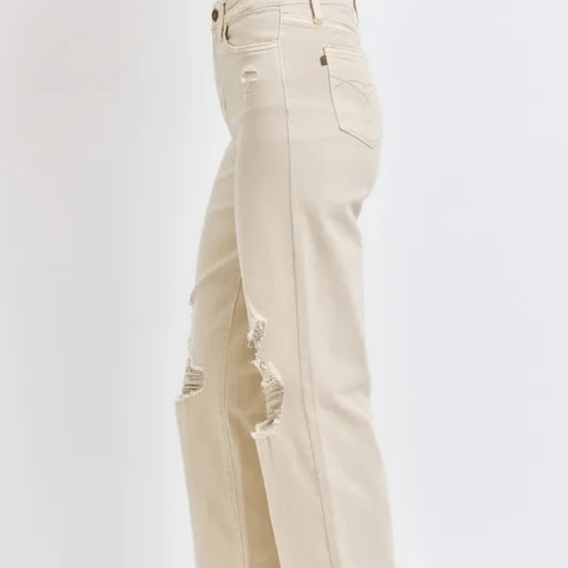 Side view of a person wearing bone-colored wide-leg jeans.