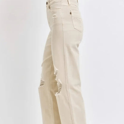 Side view of a person wearing bone-colored wide-leg jeans.